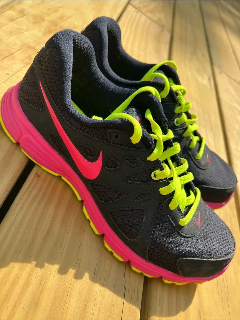 Nike Women’s navy Sneakers with Hot Pink & Neon Yellow Accents.Nike Revolution 2
